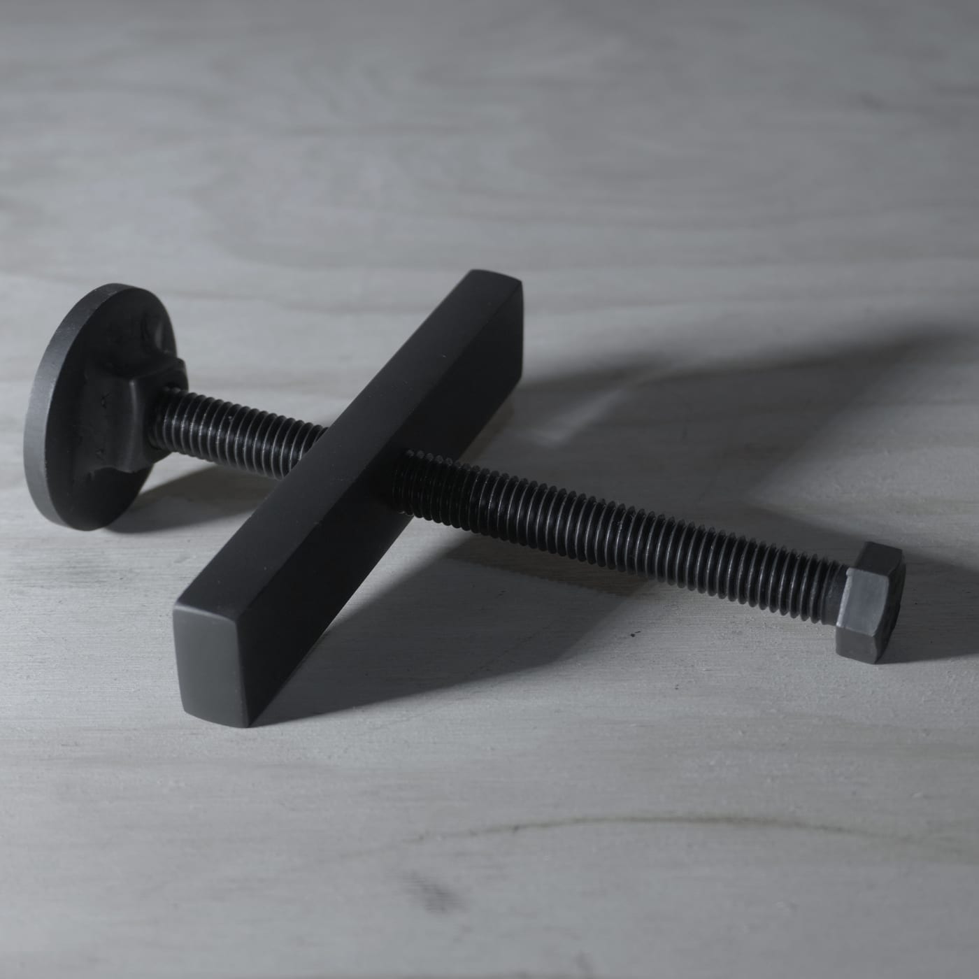 The HubPop tool: a 5-inch hot-rolled steel plate with a 1/2"-13 threaded bolt